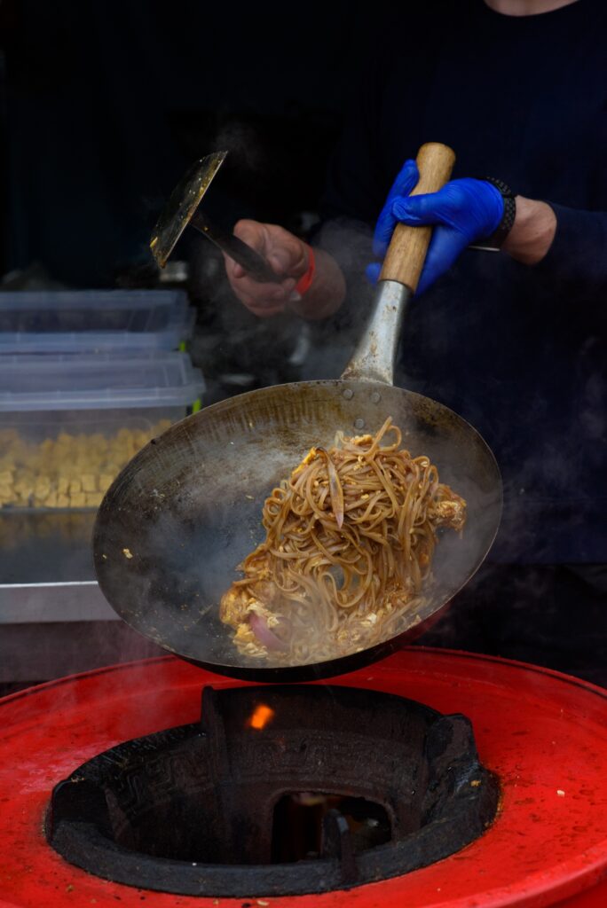 A chef prepares Chinese food at a street food festival